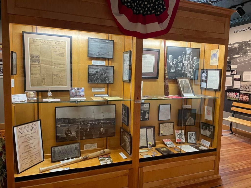An encased exhibit sharing artifacts to museum-goers at Shoeless Joe Jackson Museum and Baseball Library.