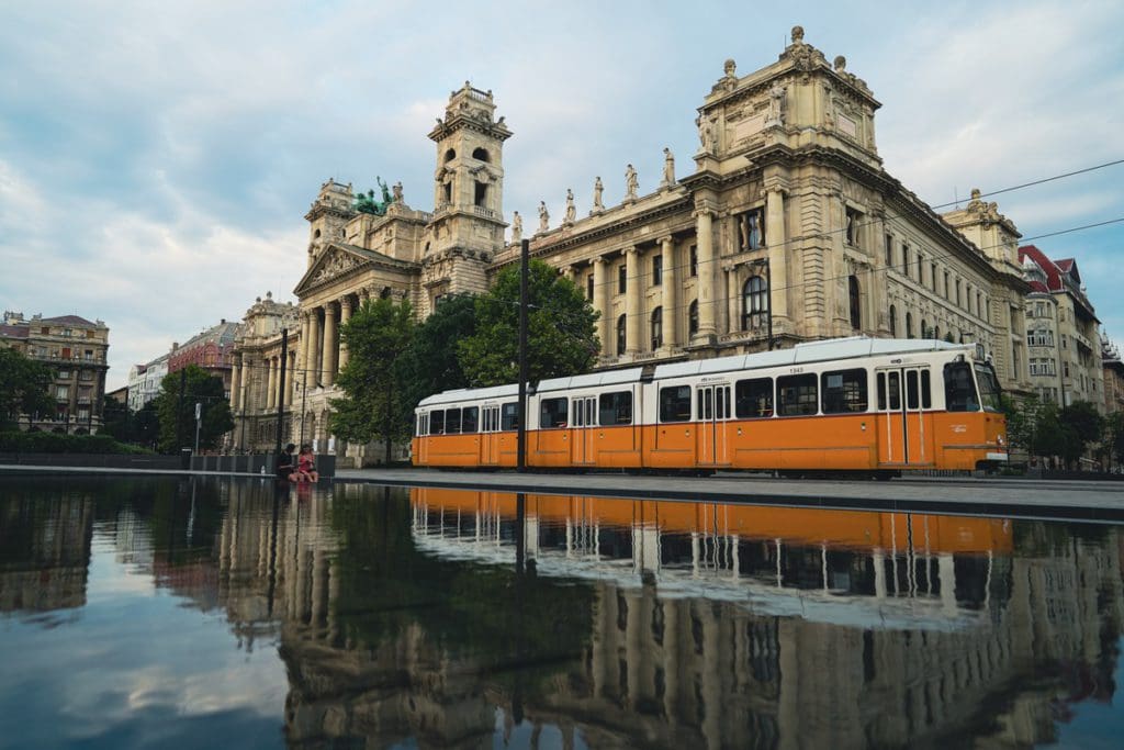 The yellow Budapest tram moves through the city.
