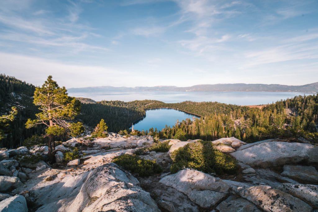 A scenic view of Lake Tahoe from atop a mountain hiking trail during the summer.