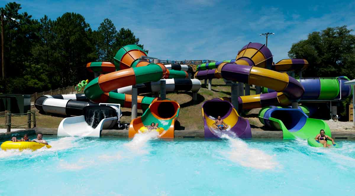 Two side-by-side waterslides empty into a large pool at Ocean Breeze Water Park, one of the best water parks near Washington DC for families.