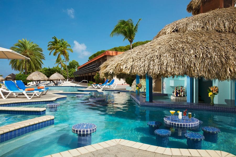The swim-up bar and cabanas at Sunscape Curaçao Resort, Spa & Casino, one of the best Curacao resorts with kids.