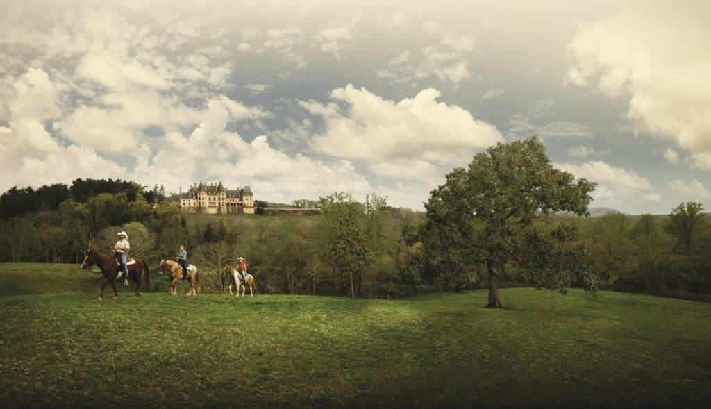A guide leads a tour on horseback around the Biltmore Estate.