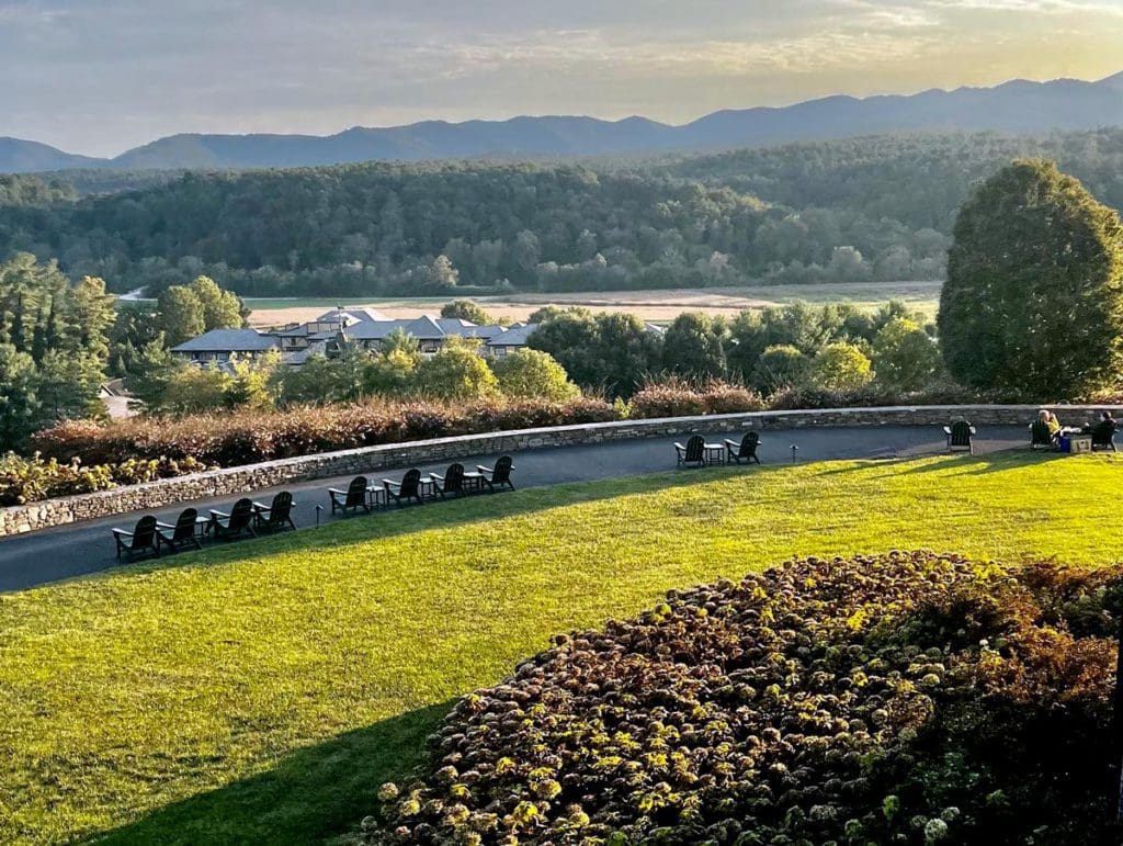 A stunning view from the lawn of the Biltmore Estate, with chairs facing the mountains.