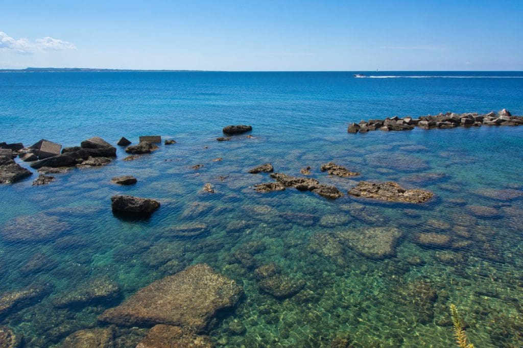 Clear-blue waters off-shore from Gallipoli, one of the best places to visit in Puglia with kids.