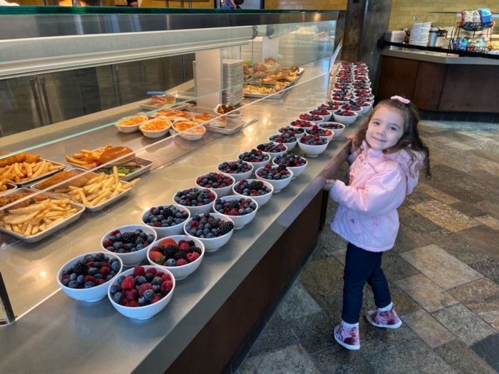 A young girl looks at an array of food at the dining area in Monterey Bay Aquarium.