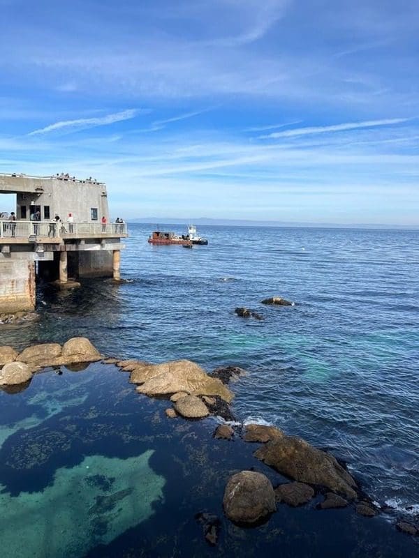 The pier at the end of the deck of Monterey Bay.