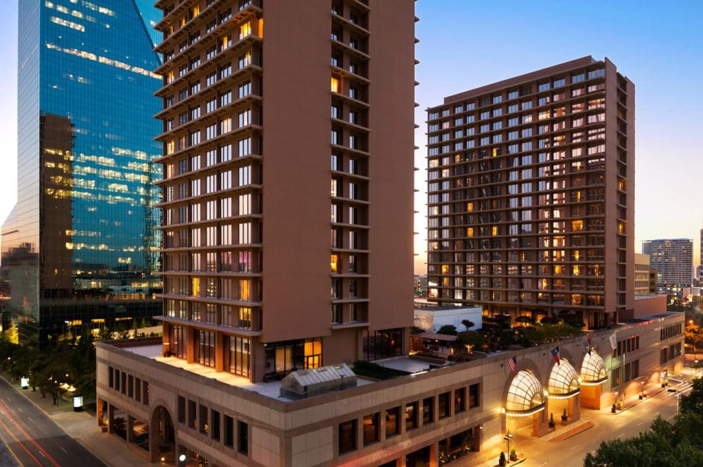 The exterior of the Fairmont Dallas lit up at night, one of the best hotels in Dallas for families.