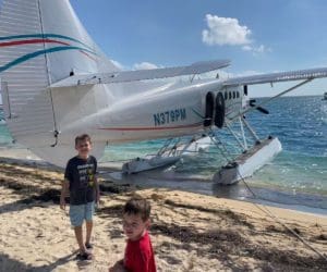 Two boys walk around a seaplane preparing to take them to Dry Tortugas National Park.