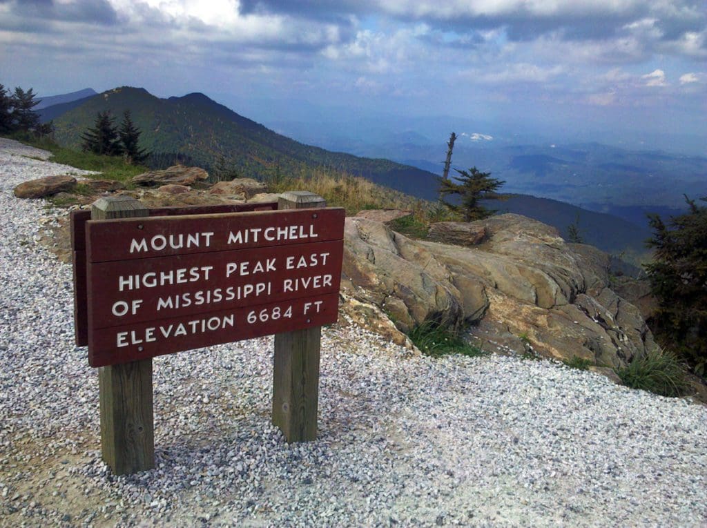 Sign at summit of Mount Mitchell. Mount Craig in background.