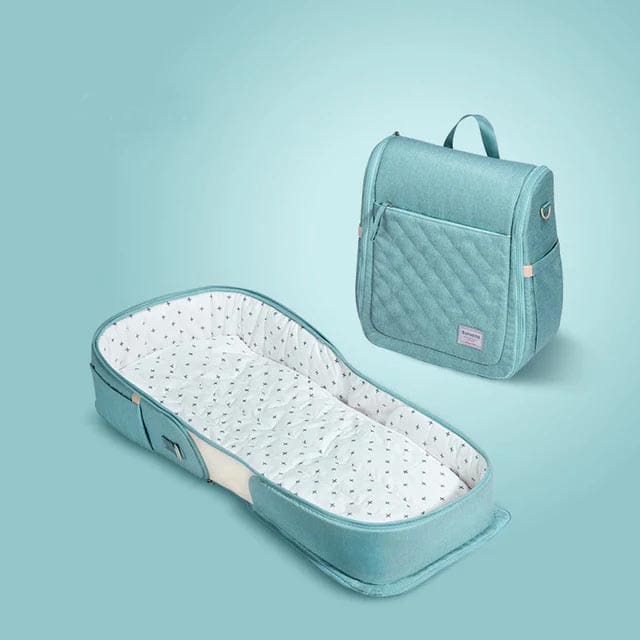 A product shot of a teal Sunveno Easy-to-Go™ Baby Portable Travel Bassinet and carrier, one of the best products for sleeping on long international flights with kids.