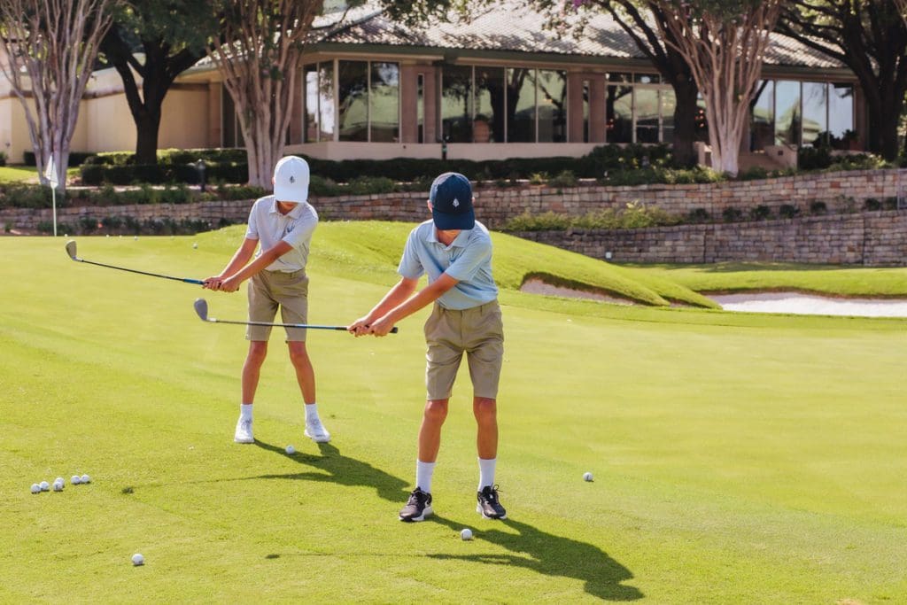 Two kids play golf, while staying at Las Colinas Resort, Dallas, one of the best hotels for families in Dallas.