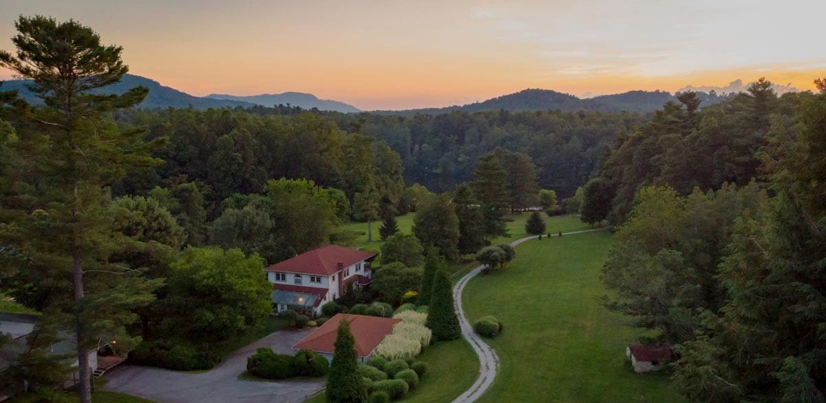 An aerial view of the grounds of Highland Lake Inn & Resort – Flat Rock at dusk.