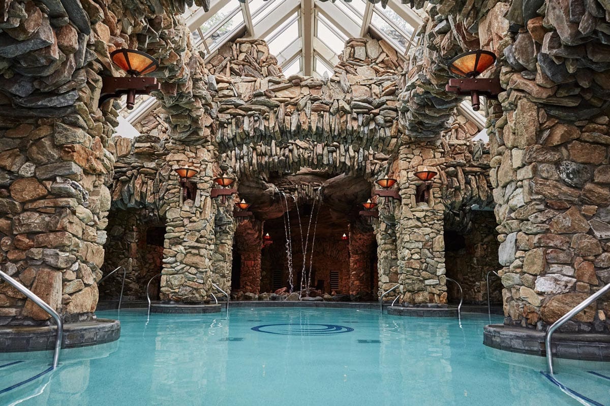 A highly-decorative pool with an overhead skylight at Omni Grove Park Inn, one of the best hotels in Asheville for families.
