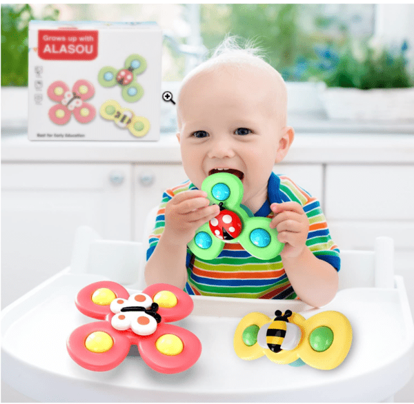 A baby puts a ALASOU spinner toy in his mouth.