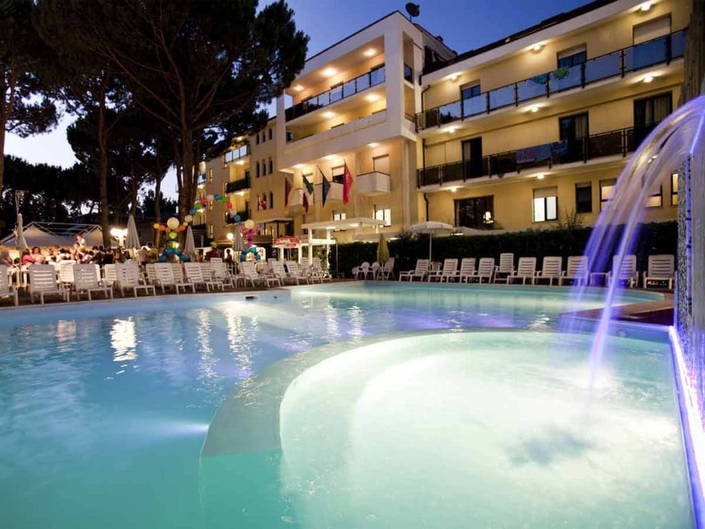 The outdoor pool at night at Club Family Hotel Milano Marittima, one of the best all-inclusive resorts In Italy with kids.