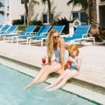 A mother and her daughter enjoy a class of tropic juice poolside at Edgewater Beach Hotel.