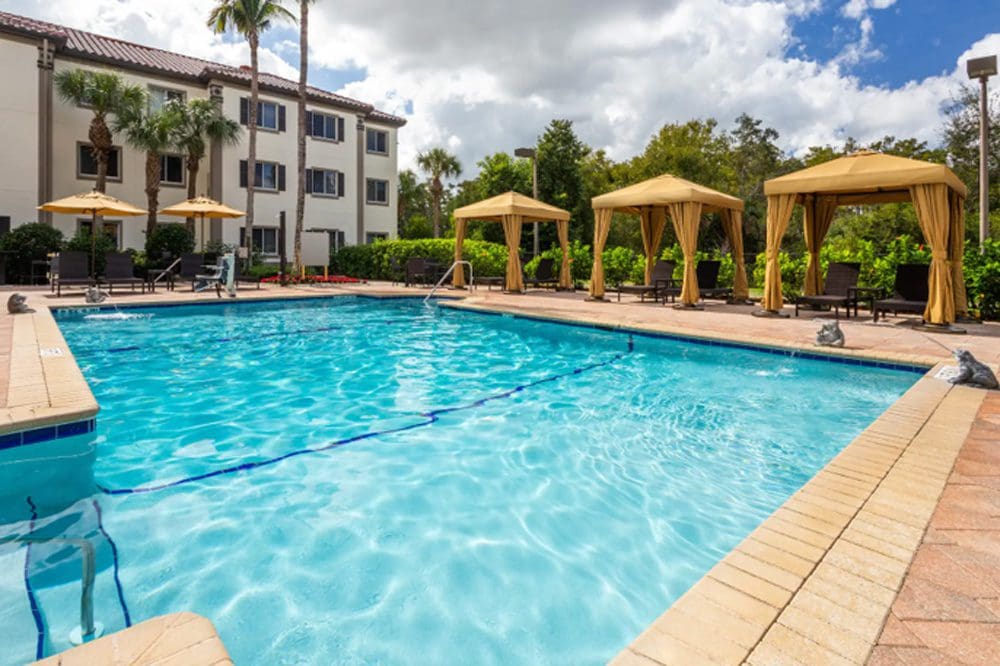 The pool and poolside cabanas at Hawthorn Suites by Wyndham Naples.