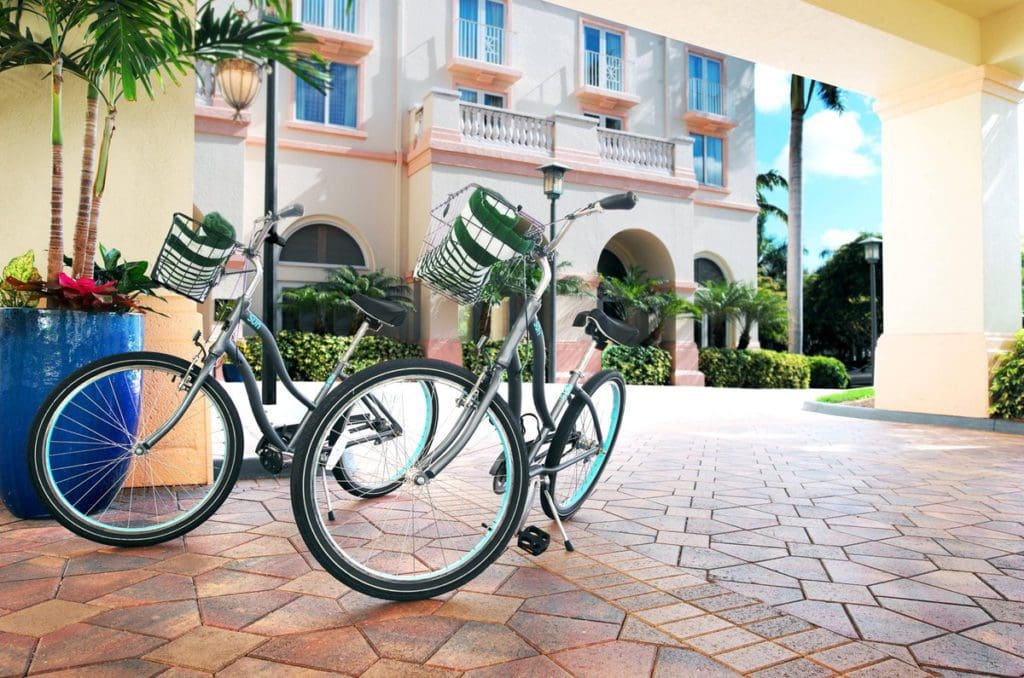 Two bicycles parked outside the entrance to Hilton Naples.
