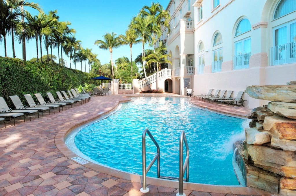 The pool and poolside loungers along the side of Hilton Naples, one of the best hotels in Naples for families.