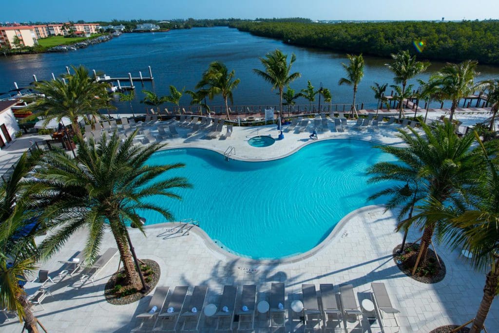 An aerial of the pool, along the oceanfront, at Hyatt House Naples/5th Avenue, one of the best hotels in Naples for families.