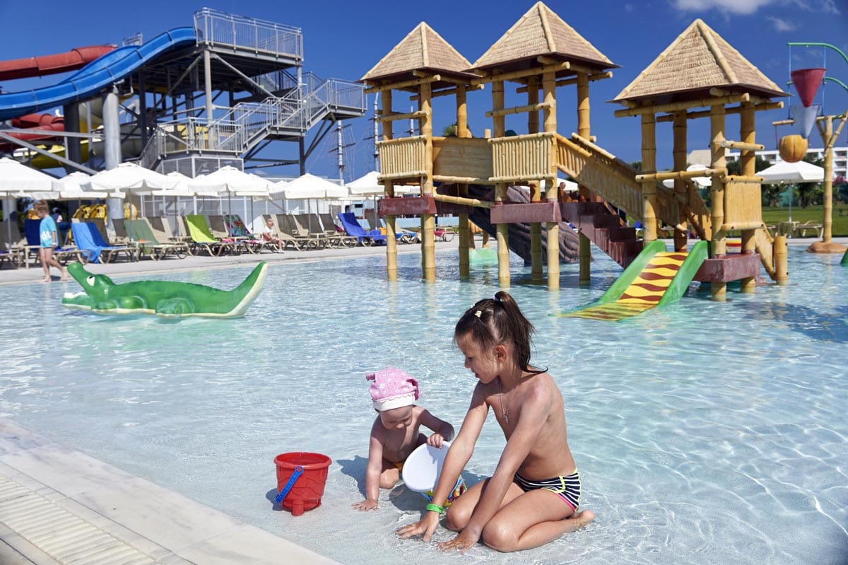 Two young girls play together in the kids' pool at Louis Phaethon Beach Resort, one of the best all-inclusive resorts in Cyprus for families.