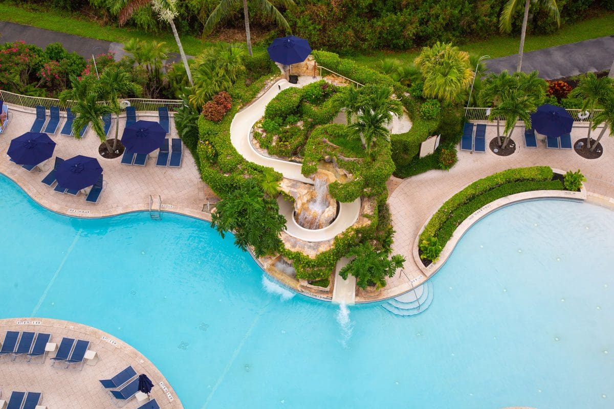 An aerial view of the pool and poolside deck at Naples Grande Beach Resort.