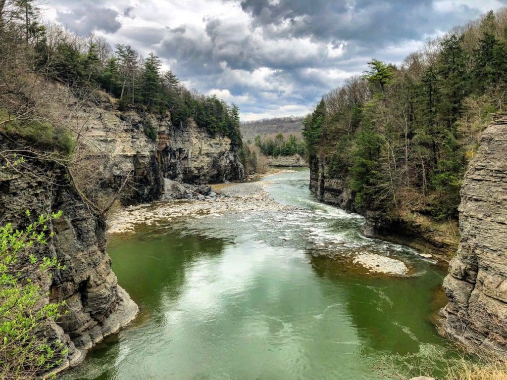 A gorge with a river flowing through from the Lower Falls inside Letchworth State Park, within the Finger Lakes region of New York.
