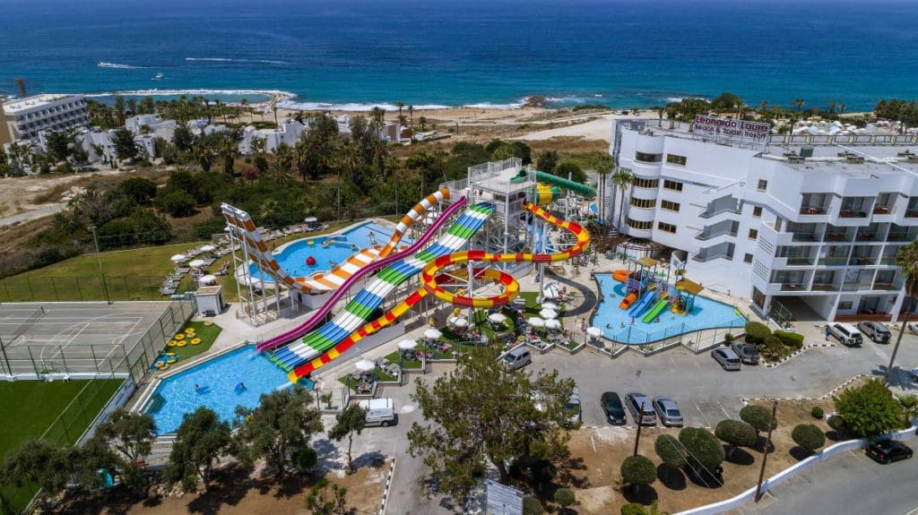 An aerial view of the on-site water park and grounds of Leonardo Cypria Bay Hotel, one of the best all-inclusive resorts in Cyprus for families.