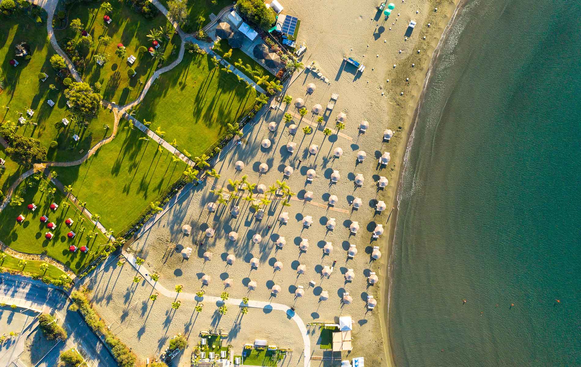 An aerial view of the beach and beach umbrellas at St Raphael Resort.