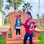 A mom and her young daughter smile in their Minnie Mouse gear while staying at Howard Johnson Anaheim.