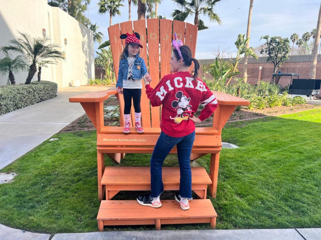 A mom and her young daughter stand together, wearing Minnie Mouse gear, while staying at Howard Johnson by Wyndham Anaheim Hotel & Water Playground.