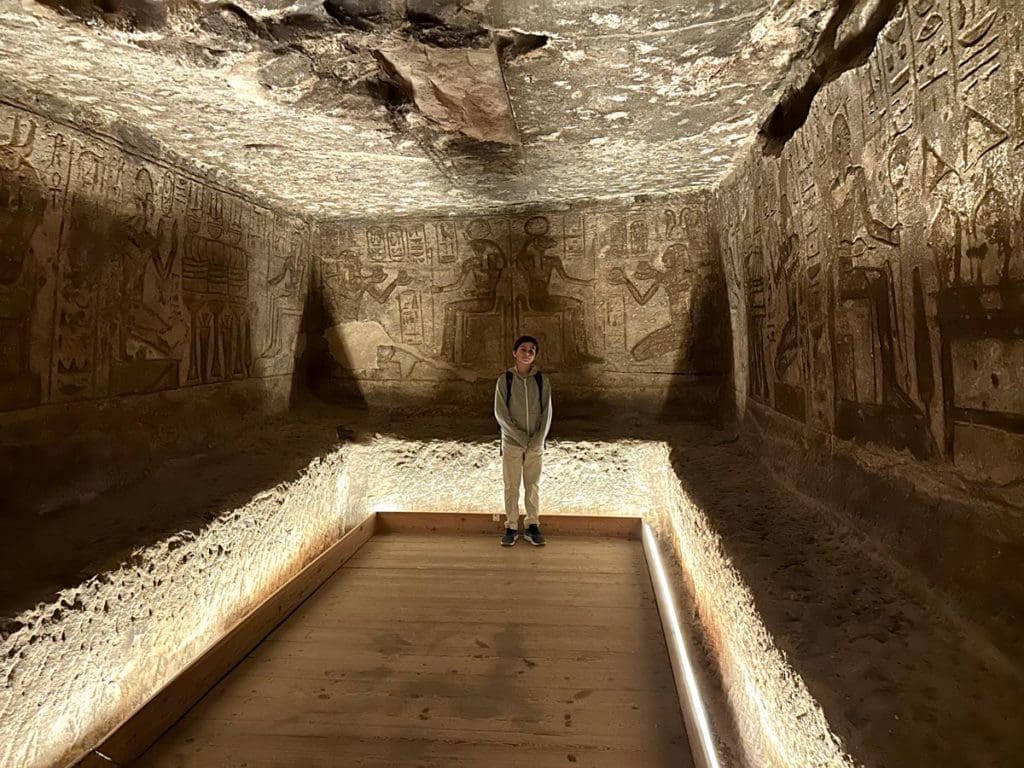 A young boy stands inside one of the internal areas of Abu Simbel.
