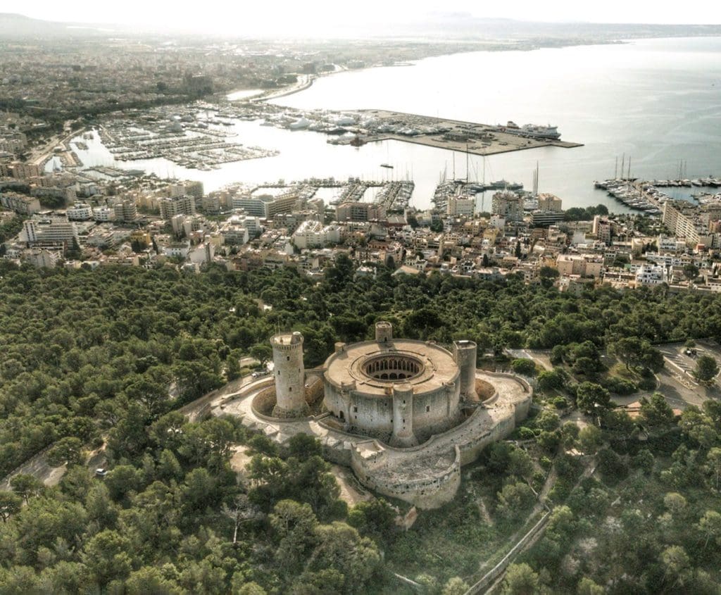 An aerial view of Castell de Bellver surrounded by forest in Palma.