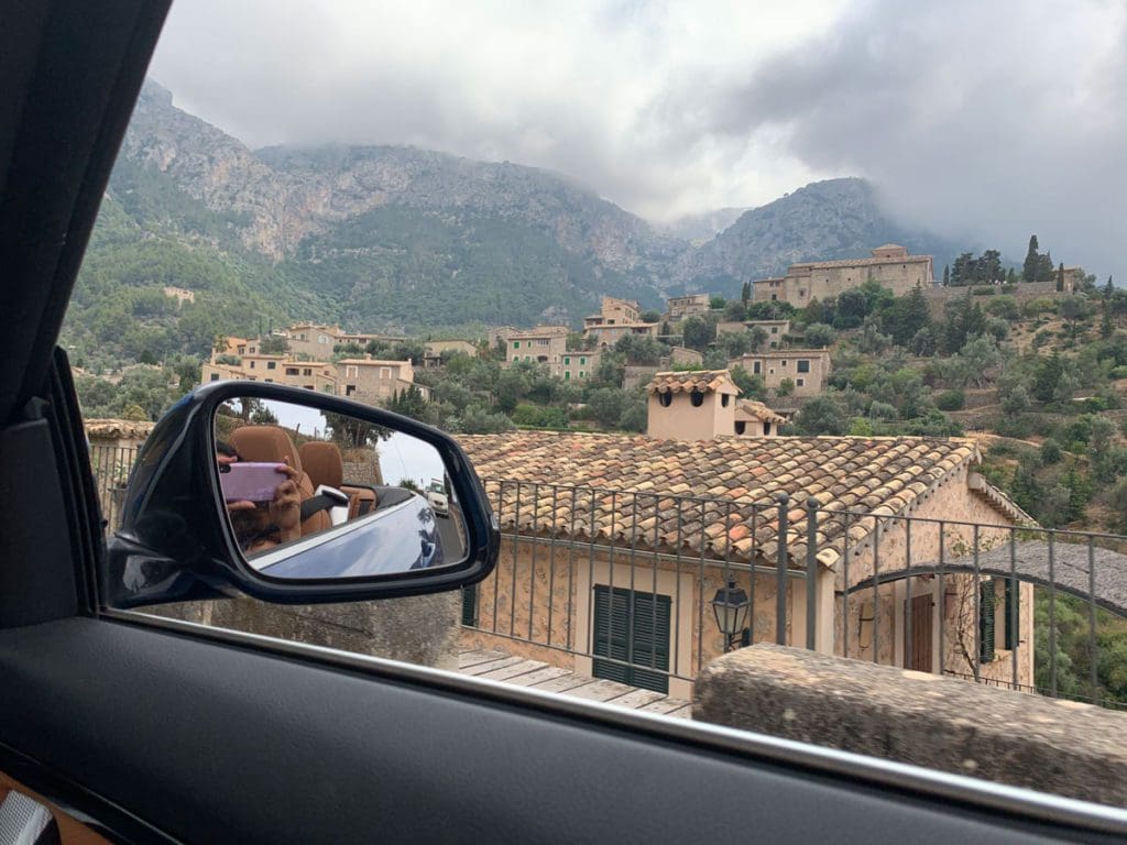A car drives around looking at mountain views in Mallorca.