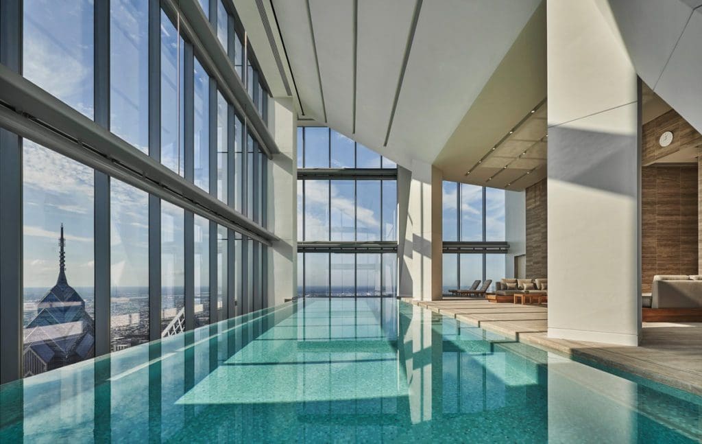 The indoor pool with floor to ceiling windows facing downtown Philly at Four Seasons Hotel Philadelphia at Comcast Center, a great accommodation option to explore one of the best US cities for a Memorial Day Weekend with kids.