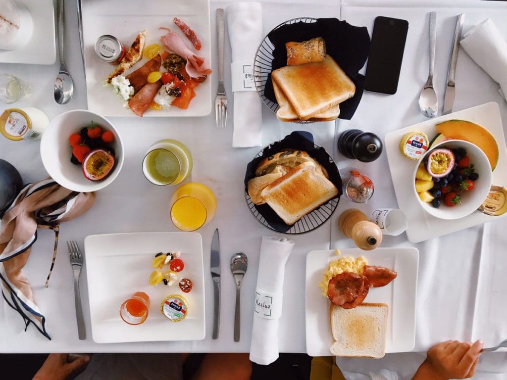 An overhead look at a tabled filled with delicious brunch food.