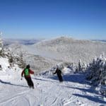Two people ski down the slopes at Smugglers' Notch Mountain in Vermont.