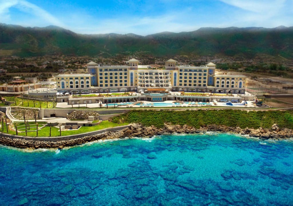 Merit Crystal Cove Hotel & Casino & Spa along a rocky ocean shoreline.