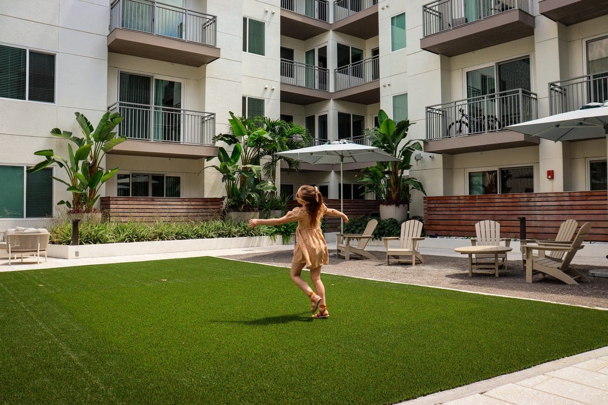 A young girl dances through the lovely courtyard at AVE Tampa RIverwalk.