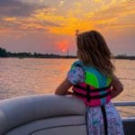 A young girl watches a sunset from a pontoon on Lake Wissota.