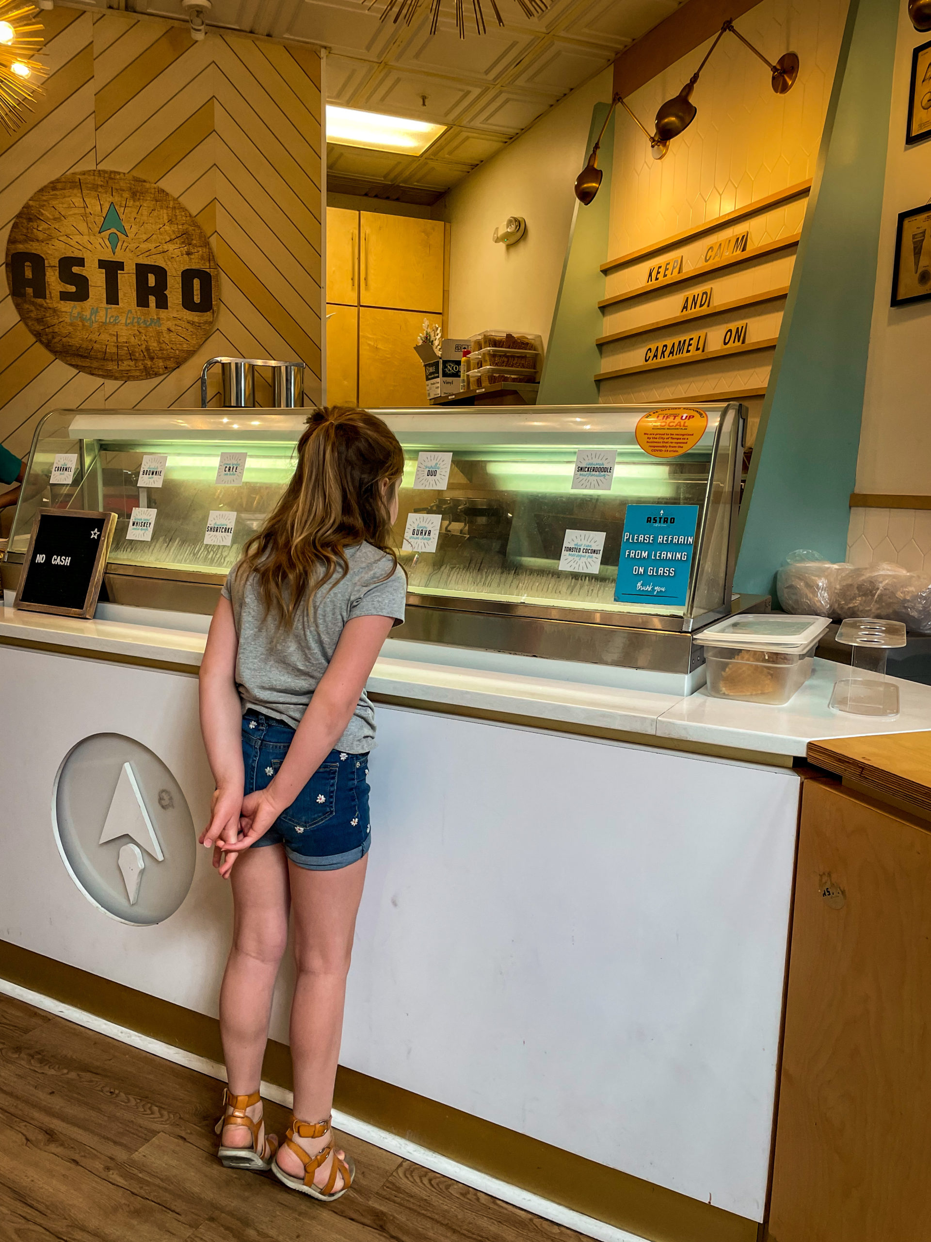 A young girl leans over to look at ice cream flavors at Astro Ice Cream in Armature Works in Tampa Bay.