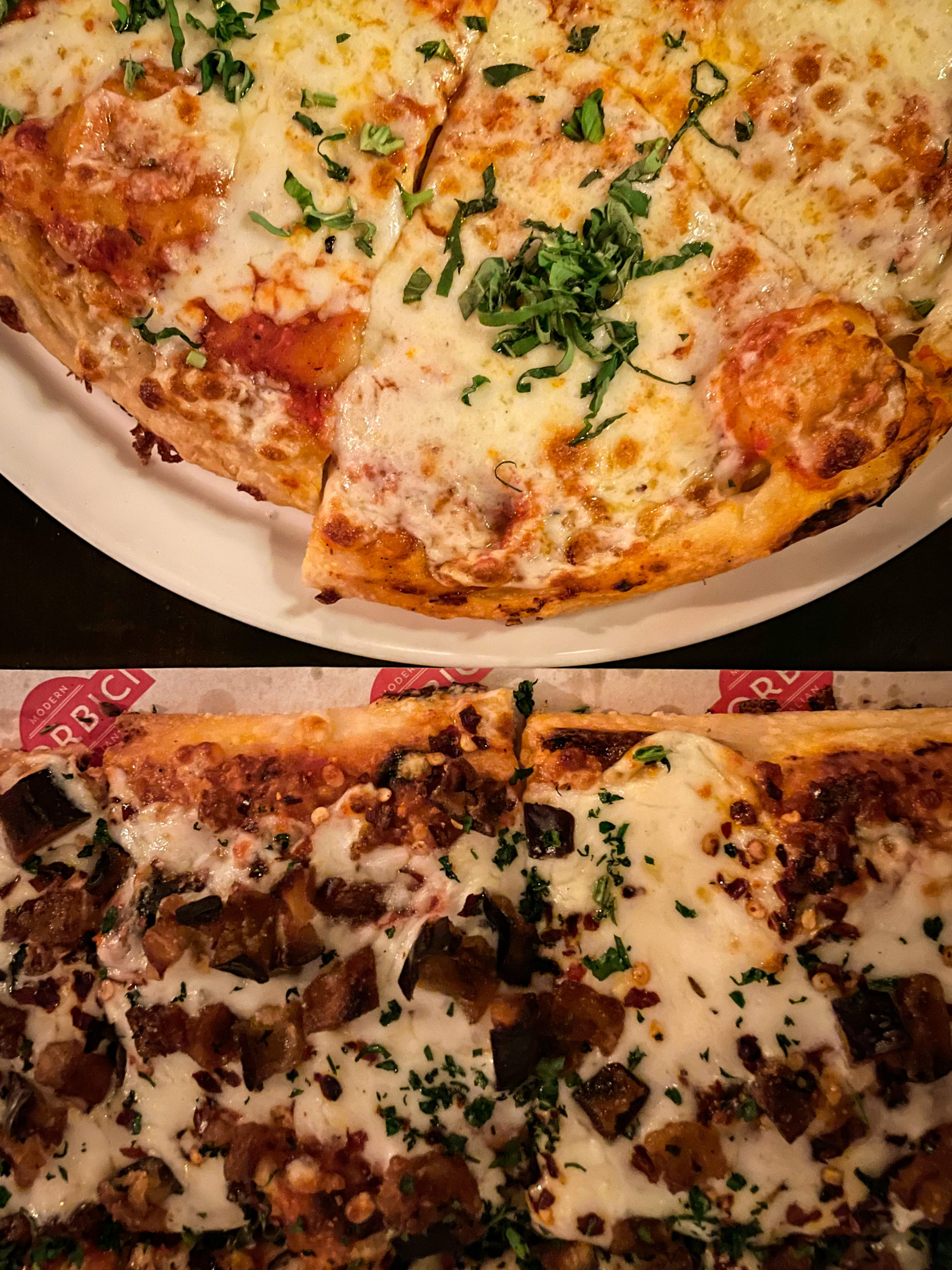 Two pizzas on a table at Forbici Modern Italian in the Hyde Park neighborhood of Tampa Bay.
