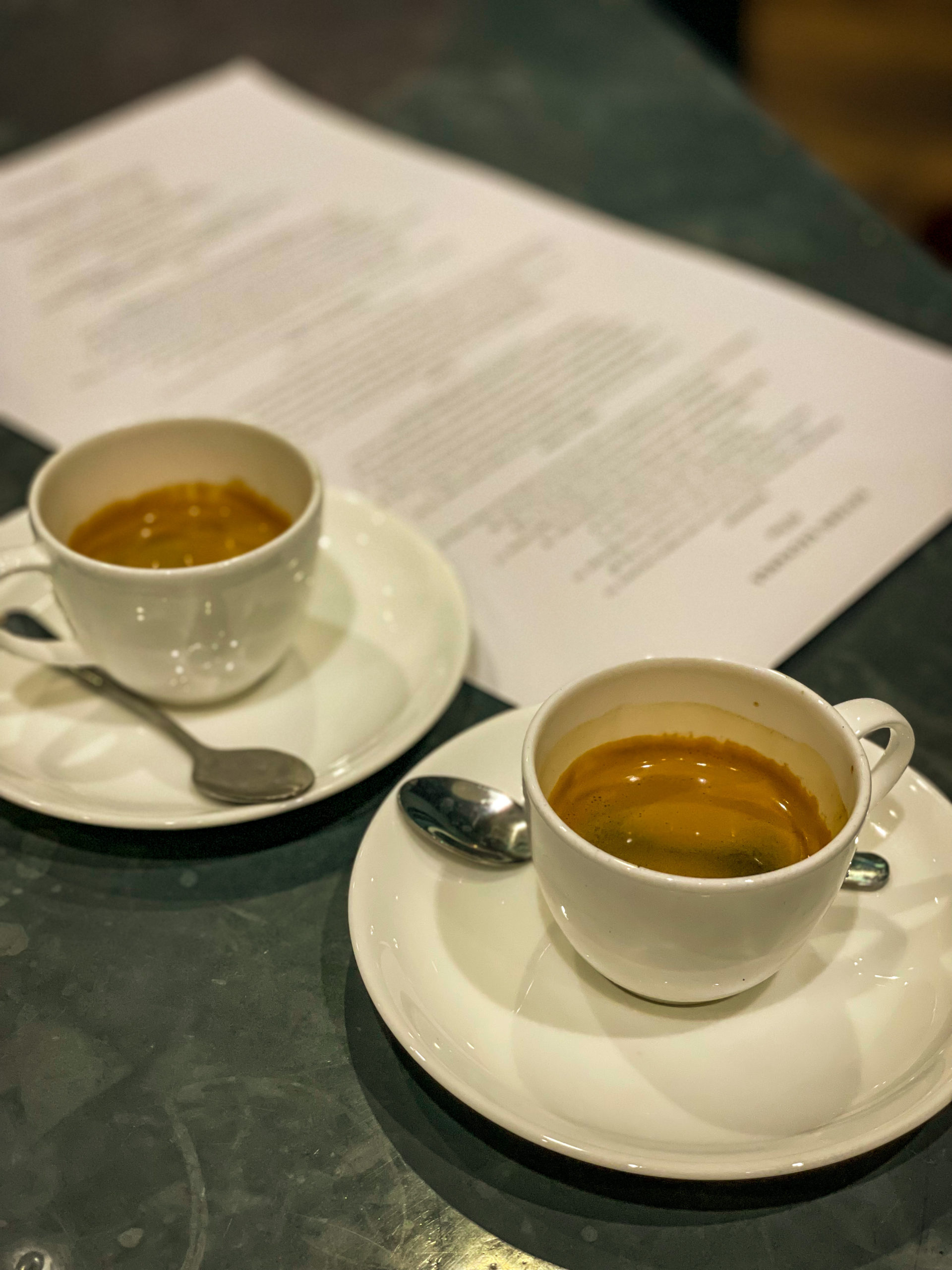 Two espresso cups sit aside a menu at Oxford Exchange.