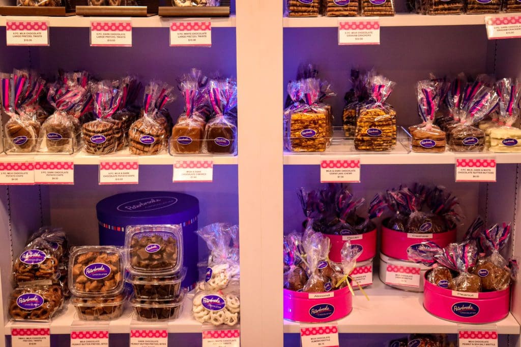 Several types of chocolate items ready for sale on a shelf at Peterbrooke Chocolatier Tampa Downtown.