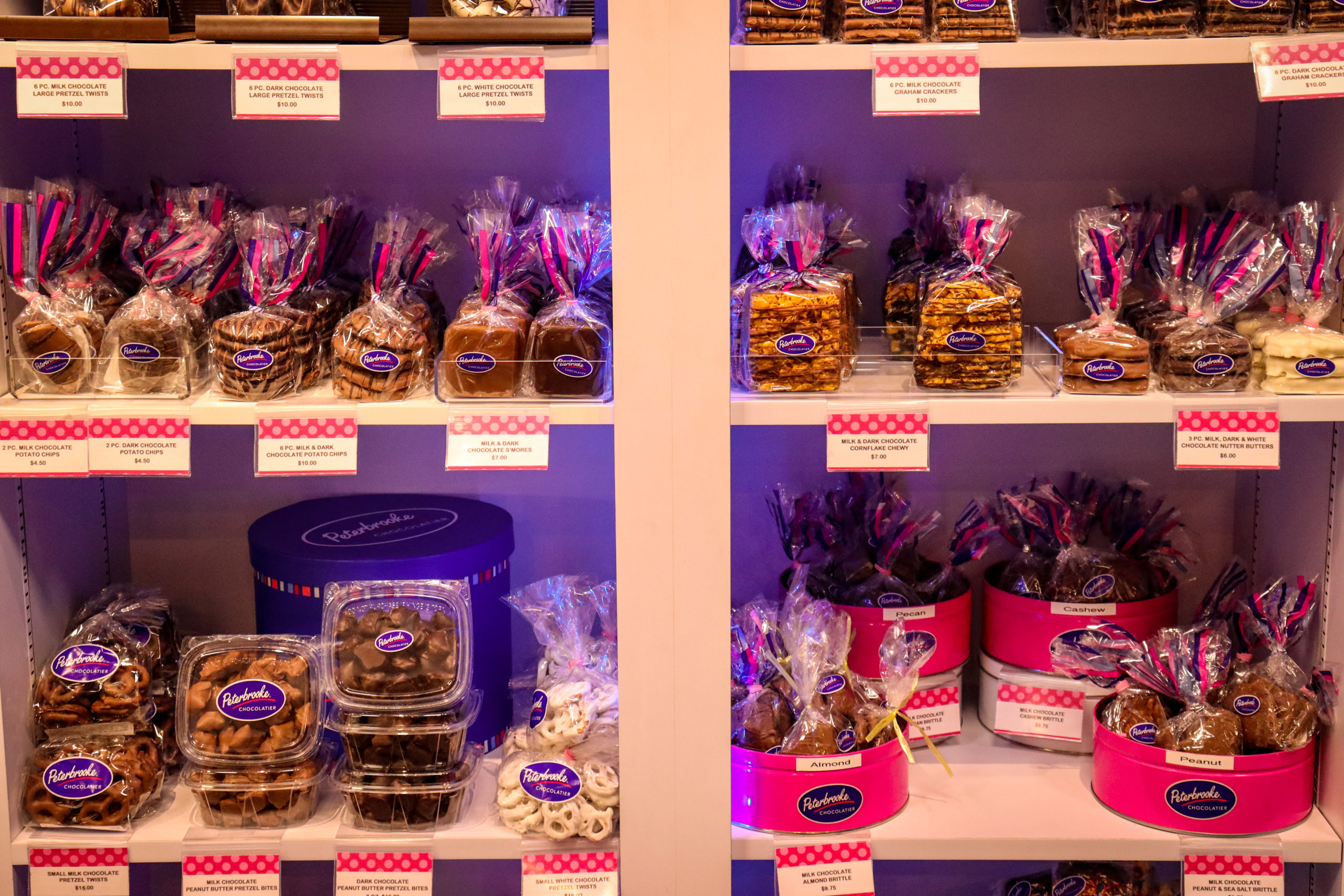 Several types of chocolate items ready for sale on a shelf at Peterbrooke Chocolatier Tampa Downtown, one of the best things to do in Tampa Bay with kids.