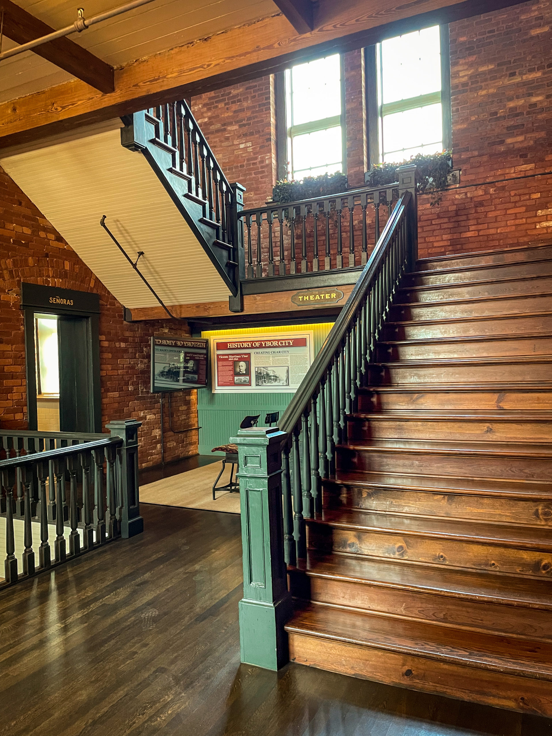 Inside the historic building, featuring exposed bricks and wooden stairs, at J.C. Newman Cigar Co. in Ybor City.