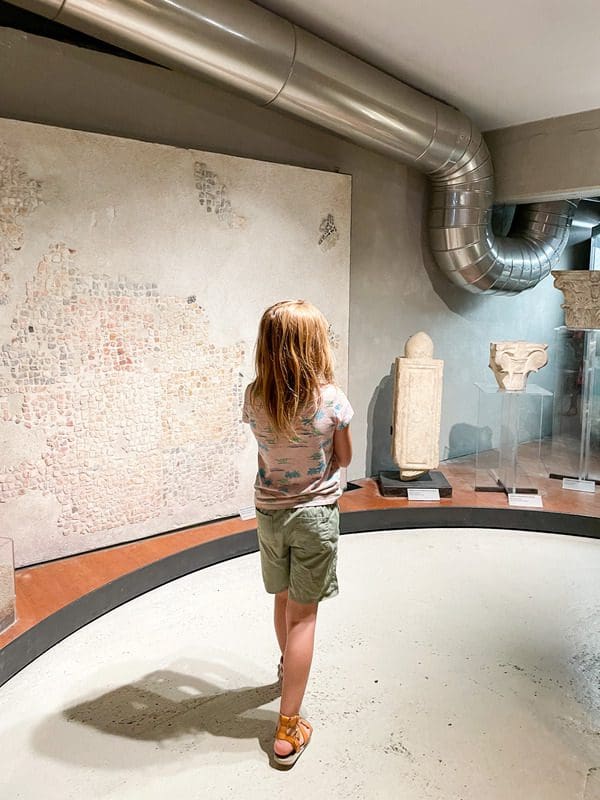 A young girl wanders through one of the underground archeology exhibits at Vicus Caprarius-the Water City.