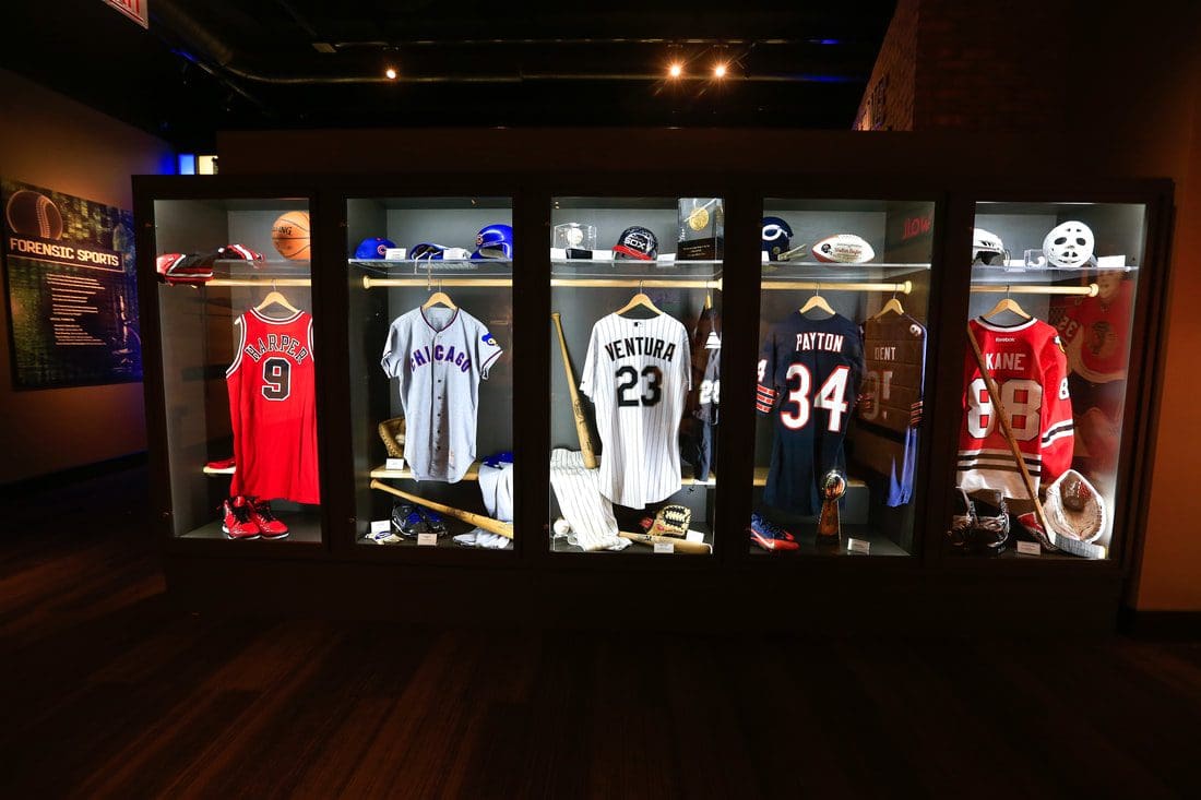 Several athletic jerseys hung on display at the Chicago Sports Museum.