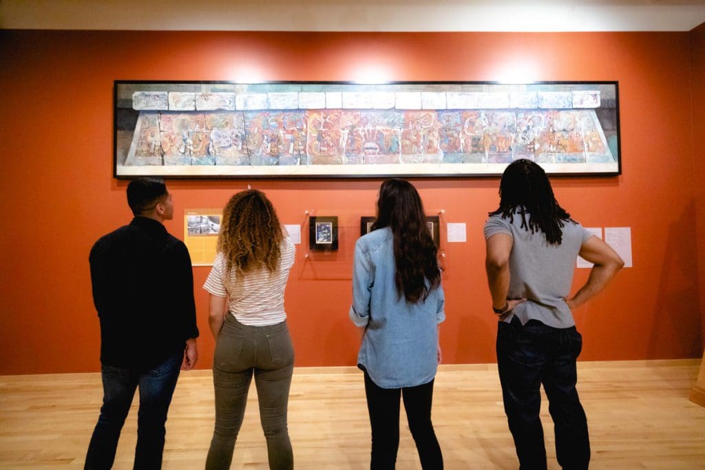 Four teens look at a piece of art in the National Museum for Mexican Art in Chicago.
