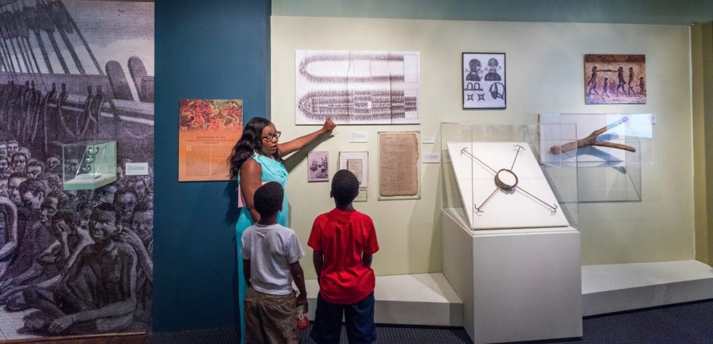 A woman and two children explore an exhibit at DuSable Museum of African American History.